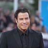 John Travolta, souriant à la projection de son film Killing Season lors du Festival du film américain de Deauville, le 6 septembre 2013.