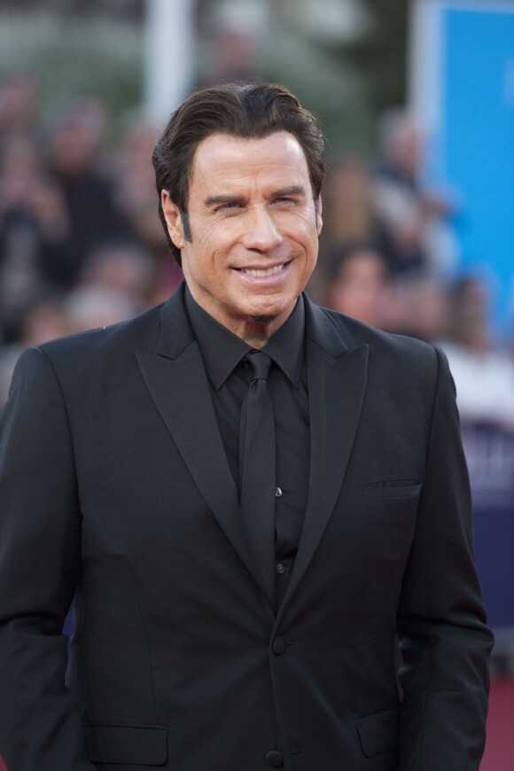 John Travolta, souriant à la projection de son film Killing Season lors du Festival du film américain de Deauville, le 6 septembre 2013.
