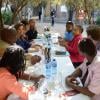 Valérie Trierweiler et Christiane Taubira lors d'une rencontre avec des militants et militantes de la cause homosexuelle ainsi qu'un couple de lesbiennes noires dans un township d'Afrique du Sud, à Kyalami, le 14 octobre 2013