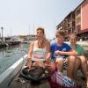 Frigide Barjot et ses deux enfants Bastien 15 ans et Contance 12 ans en bateau dans le port à côté de sa propriété de Port-Grimaud le 18 juillet 2013.