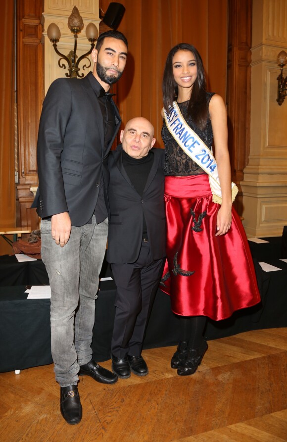 La Fouine, Paolo Calia et Flora Coquerel (Miss France 2014) au défilé de mode Oscar Carvallo Haute Couture Printemps-Ete 2014, à la mairie du 4e arrondissement à Paris, le 21 janvier 2014