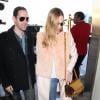 Kate Bosworth arrive à l'aéroport LAX de Los Angeles avec son mari Michael Polish, habillée d'un manteau en laine et fourrure de lapin Katie Ermilio, d'un jean Frame Denim (modèle Le Skinny de Jeanne), d'un sac doré Marni (modèe Trunk) et de chaussures Preen X Aldo Rise pour Aldo. Le 11 février 2014.