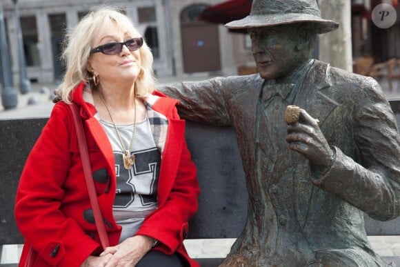Exclusif - Mylène Demongeot pose avec la statue de Georges Simenon sur un banc dans les rues de Liège. Mylène Demongeot, qui n'est pas retournée à Liège depuis 40 ans, et Pierre Simenon ont fait un pèlerinage dans la ville natale de Georges Simenon, le 27 avril 2014.