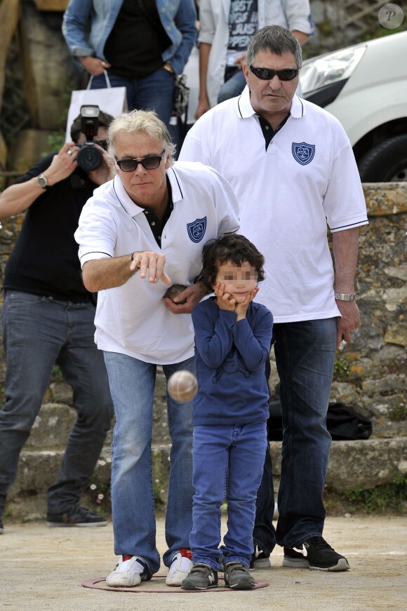 L'humoriste Franck Dubosc avec son fils Raphaël, pointe sous le regard de Jean-Marie Bigard lors de l'épreuve de pétanque organisée à Mougins dans le cadre du  1er Trophée du Sud des Alpes. 4 mai 2014