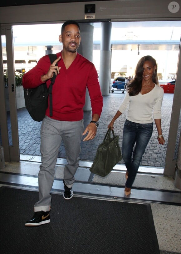Will Smith et sa femme Jada Pinkett Smith prennent l'avion à Los Angeles, le 31 décembre 2013.