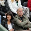 Raymond Domenech et sa compagne Estelle Denis assistent aux Internationaux de France de tennis de Roland Garros à Paris, le 27 mai 2014.