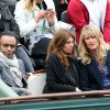 Manu Katché, sa compagne Laurence et Isabelle Camus, compagne de Yannick Noah aux Internationaux de France de tennis de Roland Garros à Paris, le 27 mai 2014, pendant le match de Gaël Monfils.