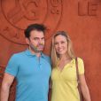 Clovis Cornillac et sa femme Lilou Fogli au village des Internationaux de France de tennis de Roland Garros à Paris, le 6 juin 2014