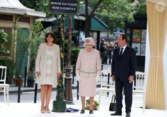 Anne Hidalgo, la reine Elizabeth II d'Angleterre, François Hollande à l'occasion d'une visite du marché aux fleurs - qui porte le nom Elizabeth II - à Paris le 7 juin 2014.