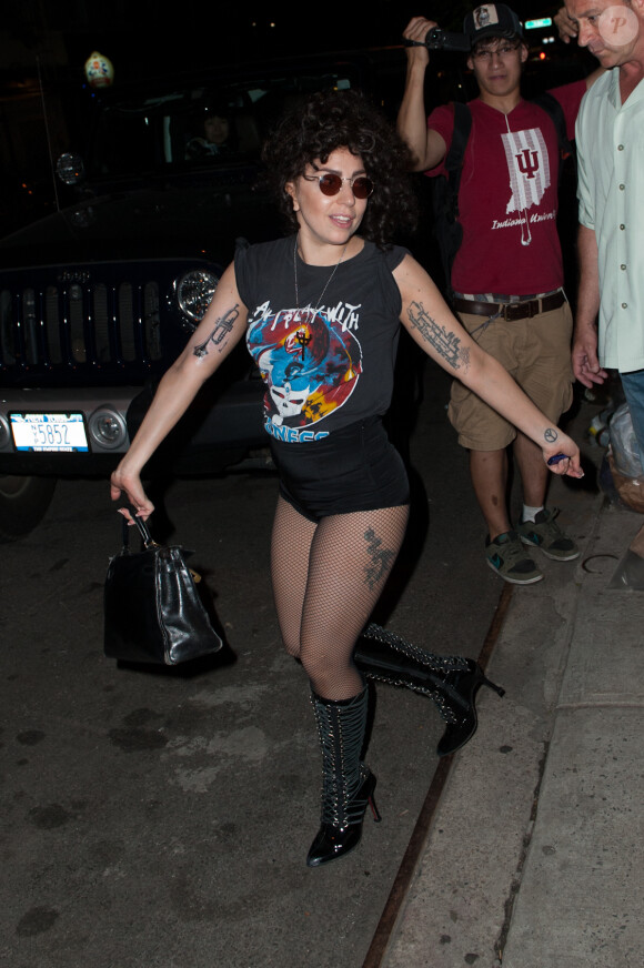 Lady Gaga montre son nouveau tatouage, un trombone sur le bras droit, à la sortie du salon de tatouage à New York. Le 18 juin 2014.