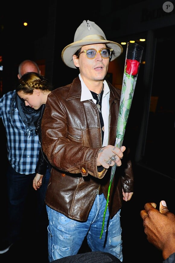 Johnny Depp et sa fiancée Amber Heard sont allés faire du shopping au magasin de livres rares Bauman sur Madison Avenue dans la soirée à New York, le 22 avril 2014, le jour de l'anniversaire d’Amber Heard. Johnny Depp a amené sa fiancée choisir un livre pour son anniversaire. Un fan a offert à l’acteur une rose destinée à Amber Heard.