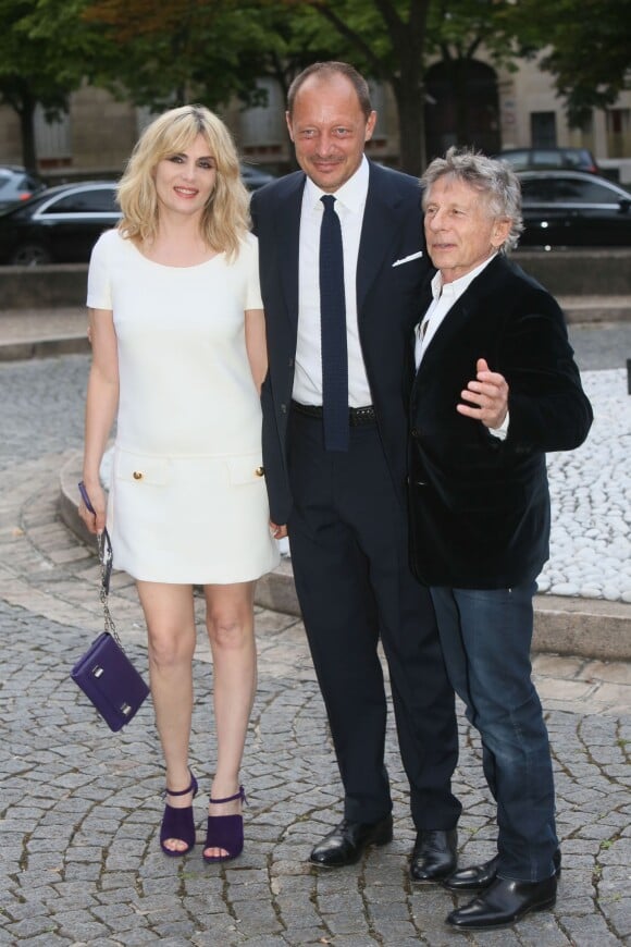 Emmanuelle Seigner, Stefano Cantino et Roman Polanski arrivent au Palais d'Iéna pour assister au défilé Miu Miu croisière 2015. Paris, le 5 juillet 2014.