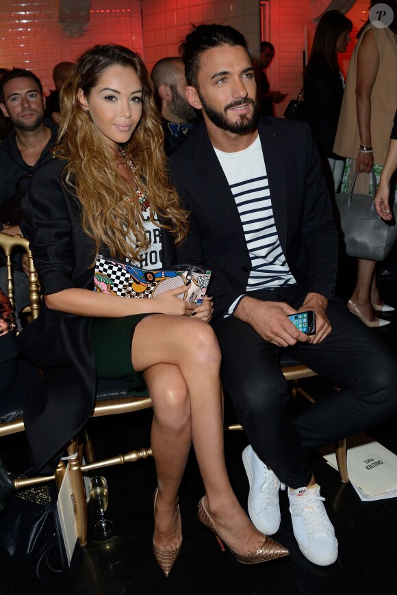 Nabilla Benattia et son amoureux Thomas Vergara assistent au défilé Jean-Paul Gaultier à Paris le 9 juillet 2014