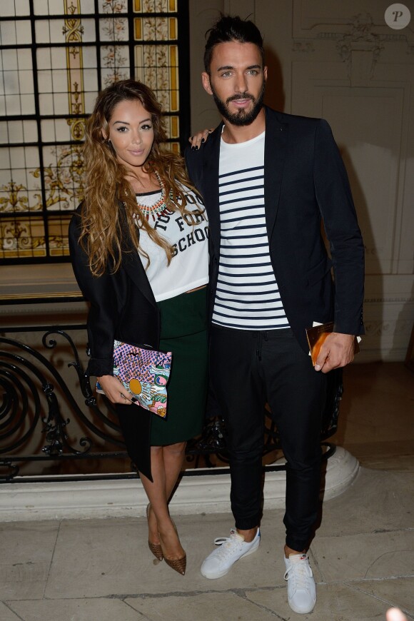 Nabilla Benattia et son amoureux Thomas Vergara assistent au défilé Jean-Paul Gaultier à Paris le 9 juillet 2014