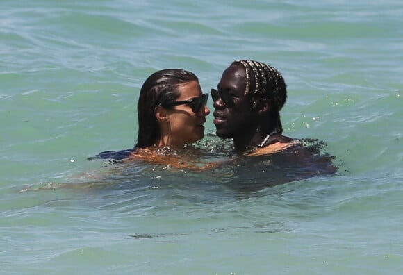Pause tendresse pour Ludivine Sagna et son époux Bacary sur la plage de Miami durant leurs vancances, le 23 juillet 2014