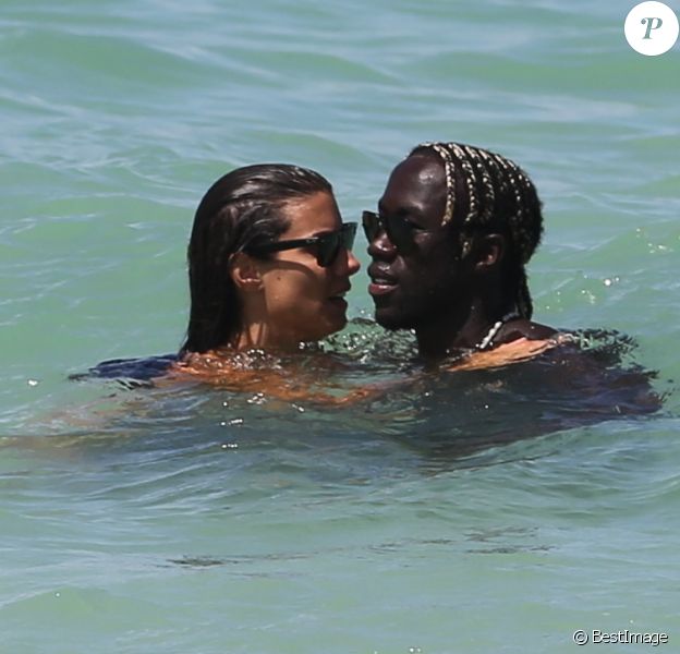 Pause tendresse pour Ludivine Sagna et son époux Bacary sur la plage de Miami durant leurs vancances, le 23 juillet 2014