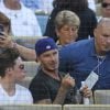 David Beckham et ses fils Brooklyn, Cruz et Romeo assistent au match de baseball des Los Angeles Dodgers au Dodger Stadium. Los Angeles, le 1er août 2014.