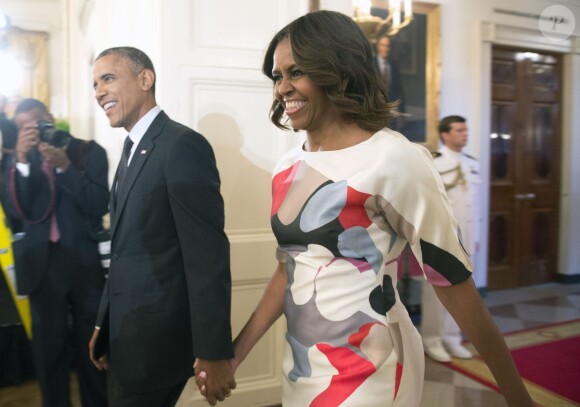 Un couple si complice ! Le 18 juillet 2014, Barack et Michelle Obama font leur arrivée à un dîner main dans la main, plus in love que jamais 