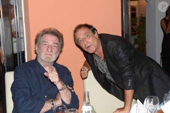 Felix Gray et Eddy Mitchell au restaurant La Bouillabaisse à Saint-Tropez, à l'occasion d'un dîner organisé par Marcel Campion, le 6 août 2014.