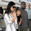 Kim Kardashian, son mari Kanye West et leur fille North à l'aéroport de Los Angeles. Le 1er septembre 2014.