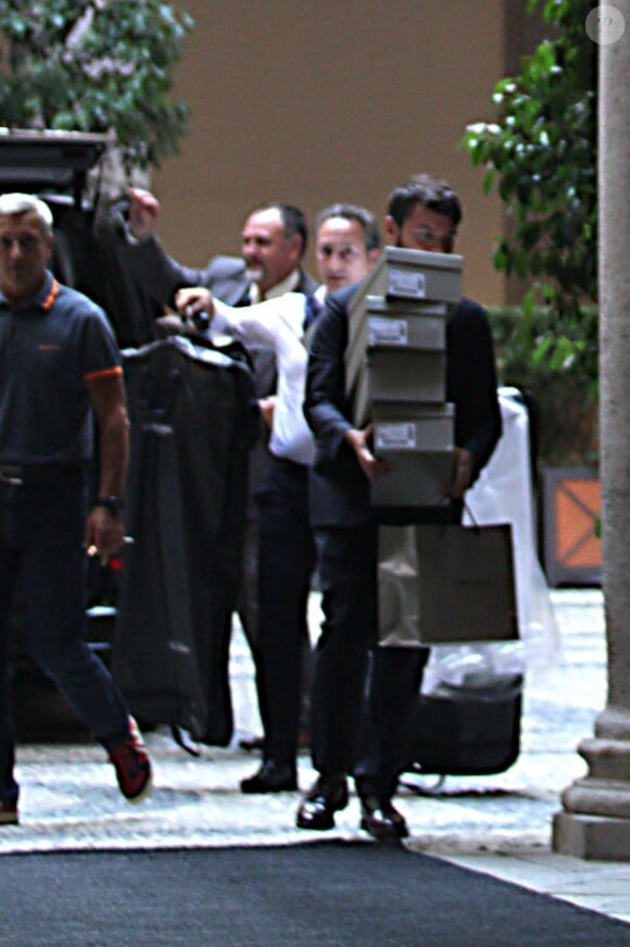 Un assistant de Giorgio Armani se rend les bras chargés de paquets à la villa de George Clooney à Laglio le 14 septembre 2014.