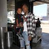 Wiz Khalifa et son fils Sebastian à l'aéroport LAX de Los Angeles le 21 août 2014.
