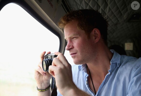 Le prince Harry prenant des photos le 8 décembre 2014 lors de son voyage privé au Lesotho pour sa fondation Sentebale.