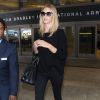 Rosie Huntington-Whiteley arrive à l'aéroport de Los Angeles, habillée d'un pull noir Zadig & Voltaire, d'un jean Paige Denim et de bottines à franges Saint Laurent. Un sac Saint Laurent (modèle Sac de Jour) et des lunettes de soleil accessoirisent son look. Le 1er février 2015.