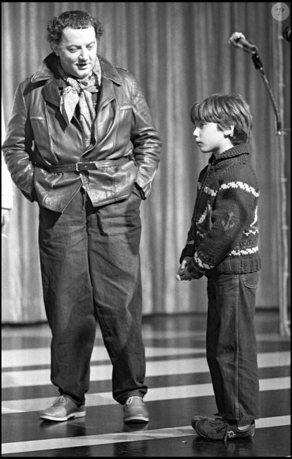 Coluche avec son fils Romain, sur scène en 1980 à Paris
