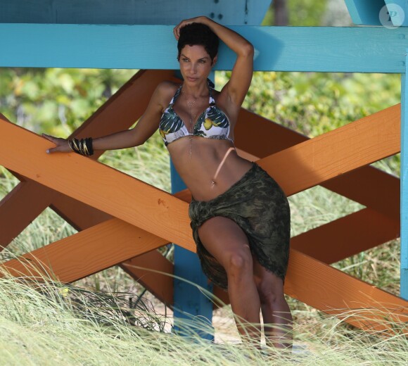 Nicole Murphy, irrésistible en bikini et paréo, se prête à un petit shooting photo sur une plage de Miami. Le 14 mai 2015.