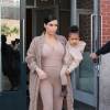 Kim Kardashian et sa fille North, toutes de beiges vêtues, quittent leur appartement à SoHo et se rendent au Skylight Modern à Chelsea, pour assister à la présentation de la collection Yeezy Season 2 de Kanye West. New York, le 16 septembre 2015.