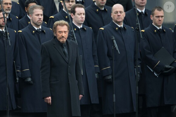 Johnny Hallyday, accompagné par Yodelice et Yarol Poupaud, chante "Un dimanche de janvier" en hommage aux victimes des attentats de janvier et novembre. Place de la République à Paris, le 10 janvier 2016.