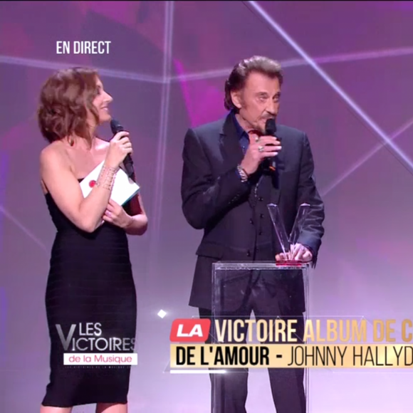 Johnny Hallyday reçoit la Victoire de l'album de chansons de l'année au côté de Yodelice (Maxim Nucci) qui a produit l'album "De l'amour" - Victoires de la musique au Zénith de Paris, le 12 février 2016.