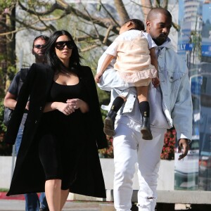Kim Kardashian et Kanye West, qui porte sa fille North endormie, sont allés faire du shopping dans un magasin pour bébé à Los Angeles. le 21 février 2016