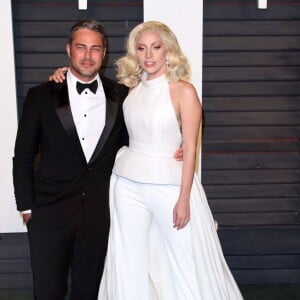 Lady Gaga et son compagnon Taylor Kinney à la soirée "Vanity Fair Oscar Party" après la 88ème cérémonie des Oscars à Hollywood. Le 28 février 2016