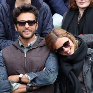 Maxim Nucci (Yodelice) et sa compagne Isabelle Ithurburu dans les tribunes des Internationaux de France de tennis de Roland-Garros à Paris. Le 24 mai 2016 © Dominique Jacovides / Bestimage