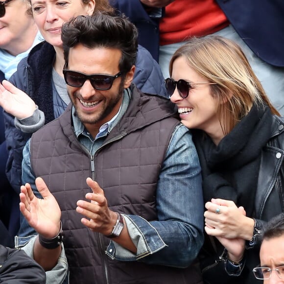 Maxim Nucci (Yodelice) et sa compagne Isabelle Ithurburu dans les tribunes des Internationaux de France de tennis de Roland-Garros à Paris. Le 24 mai 2016 © Dominique Jacovides / Bestimage