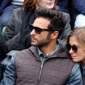 Maxim Nucci (Yodelice) et sa compagne Isabelle Ithurburu dans les tribunes des Internationaux de France de tennis de Roland-Garros à Paris. Le 24 mai 2016 © Dominique Jacovides / Bestimage