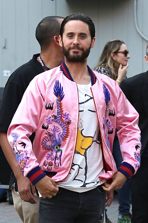 Jared Leto waves to the cameras at Comic Con while promoting "Suicide Squad" standing out in a bright pink satin bomber, graphic tee, ripped jeans, and Vans sneakers in San Diego, CA, USA on July 23, 2016. Photo by GSI/ABACAPRESS.COM24/07/2016 - San Diego