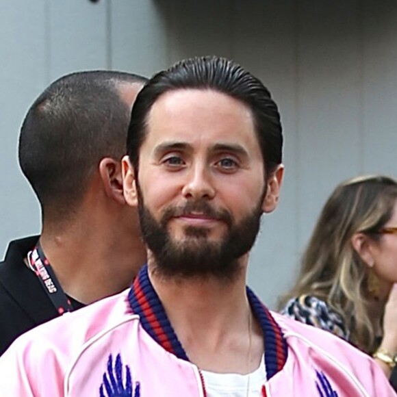 Jared Leto waves to the cameras at Comic Con while promoting "Suicide Squad" standing out in a bright pink satin bomber, graphic tee, ripped jeans, and Vans sneakers in San Diego, CA, USA on July 23, 2016. Photo by GSI/ABACAPRESS.COM24/07/2016 - San Diego