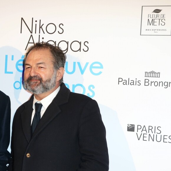 Nikos Aliagas et Denis Olivennes - Vernissage de l'exposition "L'épreuve du Temps" de Nikos Aliagas au Palais Brongniart à Paris, le 16 janvier 2017.
