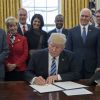 US President Donald J. Trump (C) signs an executive order entitled, 'Comprehensive Plan for Reorganizing the Executive Branch', beside members of his Cabinet in the Oval Office of the White House in Washington, DC, USA, 13 March 2017. Credit: Michael Reynolds / Pool via CNP - NO WIRE SERVICE - Photo: Michael Reynolds/Consolidated News Photos/Michael Reynolds - Pool via CNP13/03/2017 - Washington