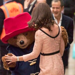 Kate Middleton, enceinte et vêtue d'une robe Orla Kiely, s'est laissé entraîner dans une danse par l'ours Paddington sur le quai de la gare de Paddington, à Londres le 16 octobre 2017, lors d'un événement du Charities Forum auquel elle prenait part avec le prince William et le prince Harry.