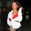 Exclusif - Rihanna arrive au restaurant 'Giorgio Baldi' à Santa Monica en Californie. Elle porte une jupe en jean noir, un haut blanc et rouge et une pochette Gucci, le 11 novembre 2017.