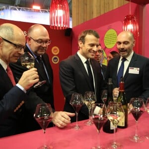 Emmanuel Macron, president de la Republique accompagne de Jean-Marie Barrillere, president du Comite National des Interprofessions des Vins (CNIV), de Stephane Travert, ministre de l'Agriculture et de Etienne Laporte sommelier (CNIV) au pavillon des vins lors de sa visite a l'occasion de l'inauguration du 55eme Salon International de l'Agriculture, au parc des expositions de la Porte de Versailles. Le 24 février 2018 © Romain Gaillard / Bestimage