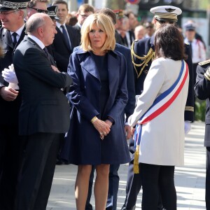 Gérard Collomb, ministre de l'intérieur, Brigitte Macron, et Anne Hidalgo, maire de Paris, lors de l'hommage à Xavier Jugelé sur les Champs Elysées, à Paris le 20 avril 2018. Une plaque a été dévoilée. © Dominique Jacovides / Bestimage