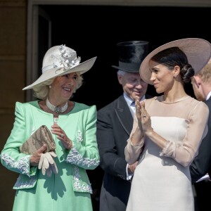 La duchesse Meghan de Sussex (Meghan Markle), vêtue d'une robe Goat, et le prince Harry prenaient part le 22 mai 2018 à une garden party organisée dans les jardins de Buckingham Palace dans le cadre des célébrations du 70e anniversaire du prince Charles. A cinq mois de la date (14 novembre 2018), le rassemblement honorait ses patronages, associations et rôles militaires.