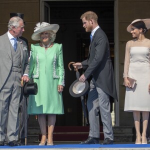 La duchesse Meghan de Sussex (Meghan Markle), en robe Goat, et le prince Harry prenaient part le 22 mai 2018 à une garden party organisée à Buckingham Palace dans le cadre des célébrations du 70e anniversaire du prince Charles. A cinq mois de la date (14 novembre 2018), le rassemblement honorait ses patronages, associations et rôles militaires.