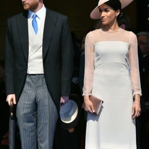 Le prince Harry, duc de Sussex, et Meghan Markle, duchesse de Sussex, lors de la garden party pour les 70 ans du prince Charles au palais de Buckingham à Londres. Le 22 mai 2018.