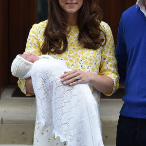 La duchesse Catherine de Cambridge (Kate Middleton) portait une robe Jenny Packham blanche à fleurs jaunes pour sa sortie de la maternité de l'hôpital St Mary le 2 mai 2015 quelques heures après la naissance de la princesse Charlotte de Cambridge.